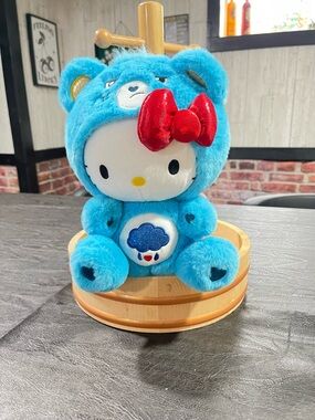 Hello Kitty Plush in Bright Blue Care Bear Costume with Red Bow